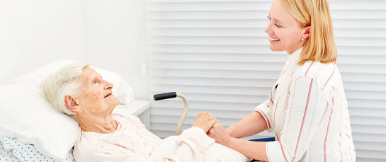 happy caregiver visiting a senior woman
