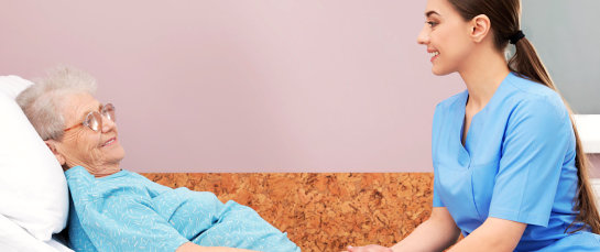 senior woman on bed talking to her nurse