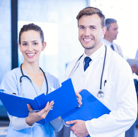 male and female doctor smiling