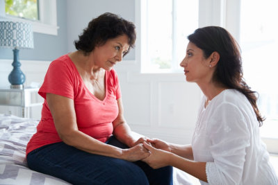 caregiver comforting a senior woman